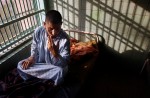 As evening comes a mental patient sits on his bed at Rashad psychiatric hospital Wednesday.