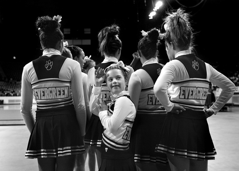 Megan Bomgaars, 14, waves to friends and supporters at the State Cheerleading finals at the Denver Coliseum in Denver, Colorado. Megan, who has Down Syndrome, tried out and made it onto the Evergreen High School cheerleading squad. The girls on the squad have rallied around Megan and made sure that she is part of the team.