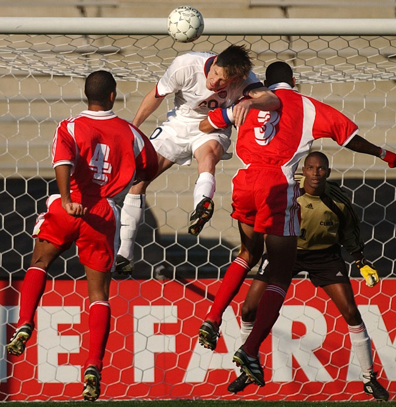 Brian McBride, of the USA National team, is sandwiched by Mario Rodriguez, left, and Jeniel Marquez, right, on a center in front of Cuba's goal. USA won 1-0 on a penalty kick.
