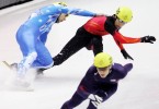 Alex Izykowski, of the USA, pulls away as Yuri Confortola, upper left, of Italy, and Takahiro Fujimoto, of Japan, upper right, collide in the men's 5000 meter relay semifinal in short-track speed skating at the 2006 Winter Olympics.