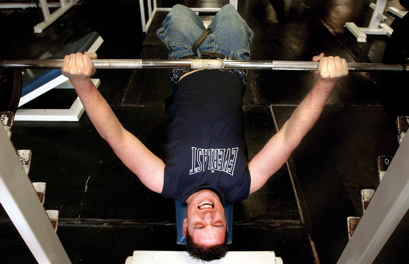 Jonathan Swain bench presses at his gym in Vernal, Utah. Jonathan works out as often as he can but his job and his health can interfere. Sometimes he feels to sick to work out.