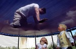 Jonathan Swain plays with his fiance's children, Alicia, 5, and Stanley, 4, Padigimus, on the trampoline at their home. Jonathan is extremely close to both of Amber's children and acts like both a father and a playmate.