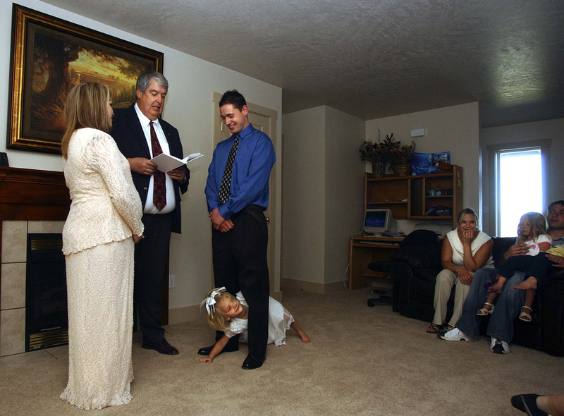 Alicia crawls between the legs of Jonathan in the middle of his wedding ceremony to Amber at their home in Vernal, Utah. Amber's family are devout Mormons and were hesitant to accept their daughter's relationship with Jonathan.