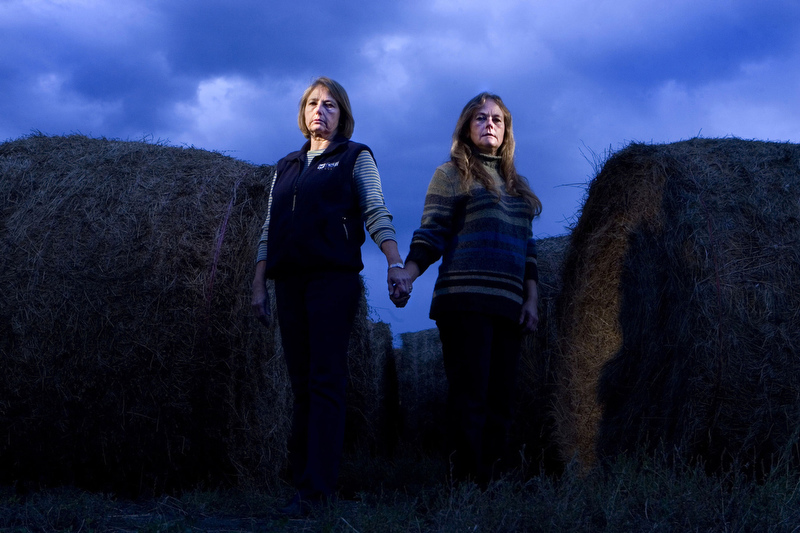 Colleen Yetter Lackey, left, and her sister, LaDean Yetter Long, stand in a field near their parents' home in Weld County. They continue to feel the pain of losing many of their friends in the train-bus crash of Dec. 14, 1961. The sisters got up late that morning and missed the bus, but their cousin, Jerry Hembry, ran for the bus and made it. He survived.