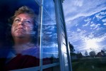 Karen Walso Schott looks out the front window of her home in Greeley. Born 11 months after the train-bus collision, she has spent a lifetime wondering about her sister, Linda, who died in the accident. 