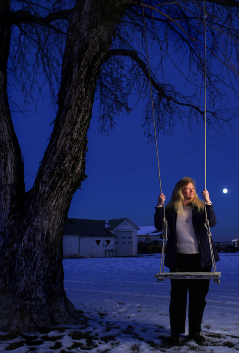 Becky Alles Badley stands near a swing outside her home in the Auburn area. Born just two months after the train-bus crash, she has many questions about her big sister, Linda Alles, who died in the accident.