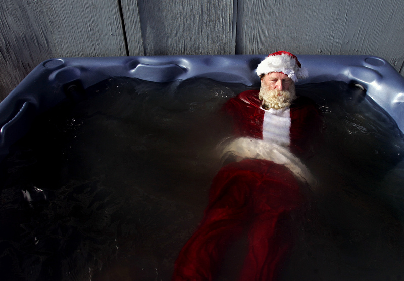 Steve Weideman, dressed as Santa Claus, warms up in the hot tub after doing the Polar Plunge on January 1st at the Boulder Reservoir in Boulder, Colorado. Proceeds go to help fund Alzheimer education, counseling, and research.